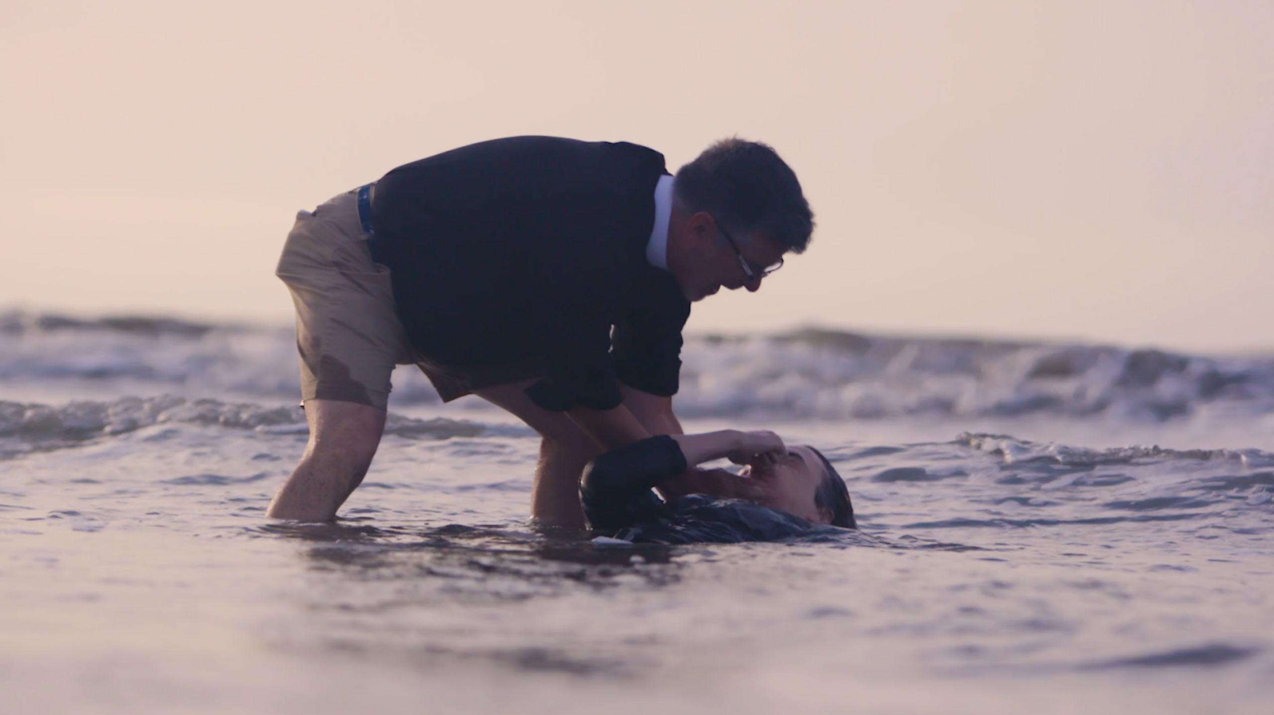 Person praying at the beach