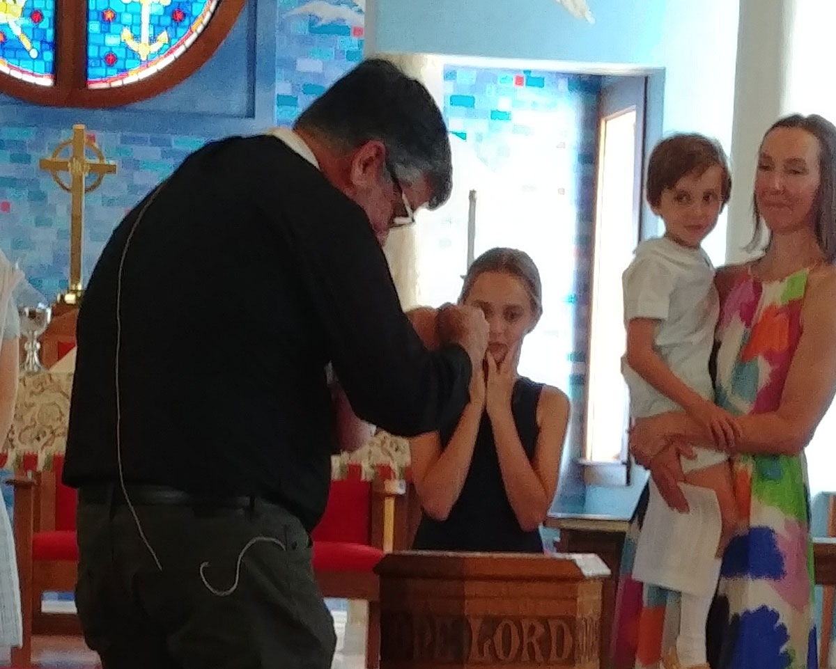 Children receiving communion blessing